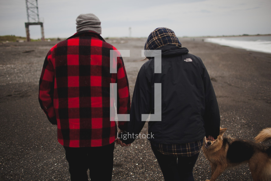 couple walking dog on a cold day