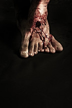 Jesus' nail scarred feet isolated on black