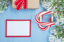 candy canes, Christmas greenery, and gift box 
