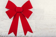 red bow on white wood background 