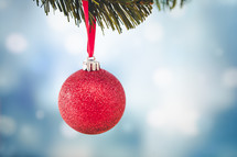 hanging red ornament ball on a Christmas tree