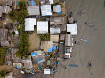 aerial view over a coastal village community 