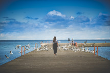 woman walking on a pier 
