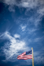 American flag on a wooden flag pole 