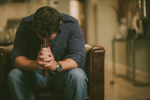 Man clutching Bible and praying