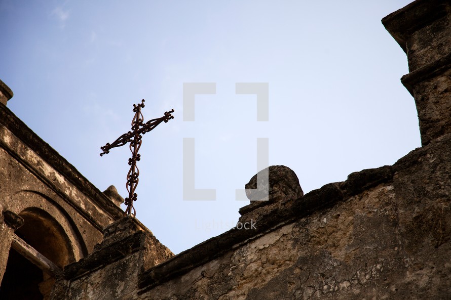 wrought iron cross on a stone building