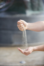 Hands sifting and catching sand