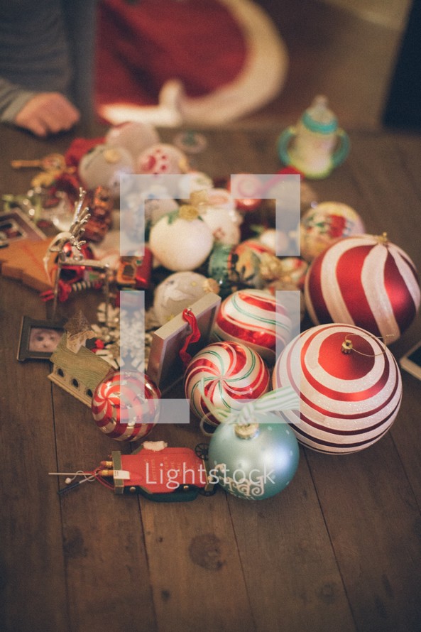 Christmas ornaments lying on wooden table.