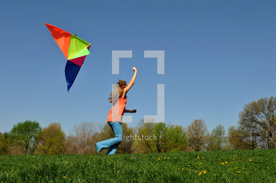 girl child running with a kite 
