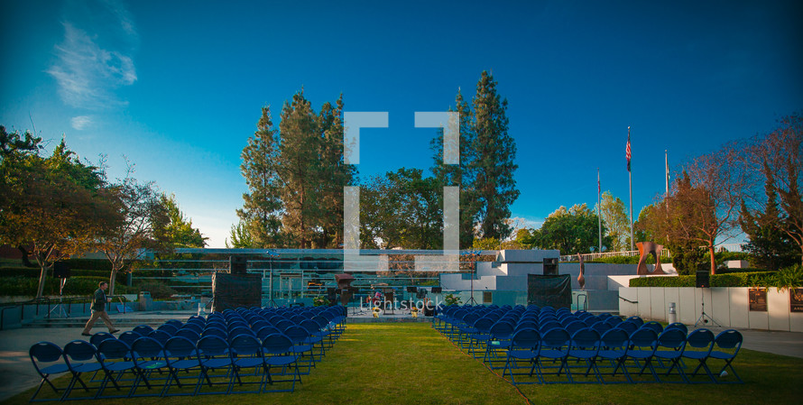 rows of folding chairs before an outdoor worship service
