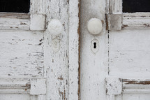 door knobs on an old weathered door 