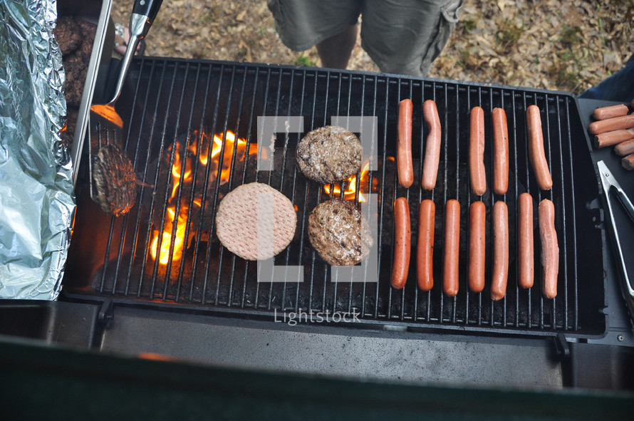 hot dogs and hamburgers on a grill