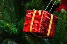 red present ornament on a Christmas tree