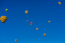 Hot air balloons bright colored in blue sky many multiple. 