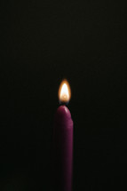 A purple Advent candle lit