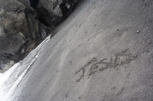 The word Jesus spelled out on beach