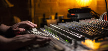 hands on a sound board
