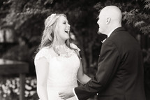 A bride and groom laughing together wedding day husband and wife 
