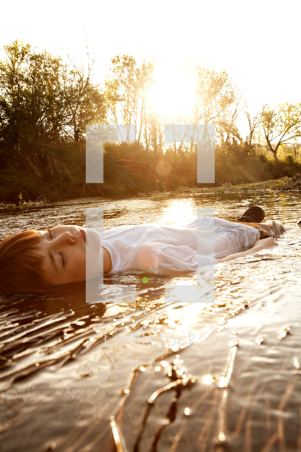 boy lying in water