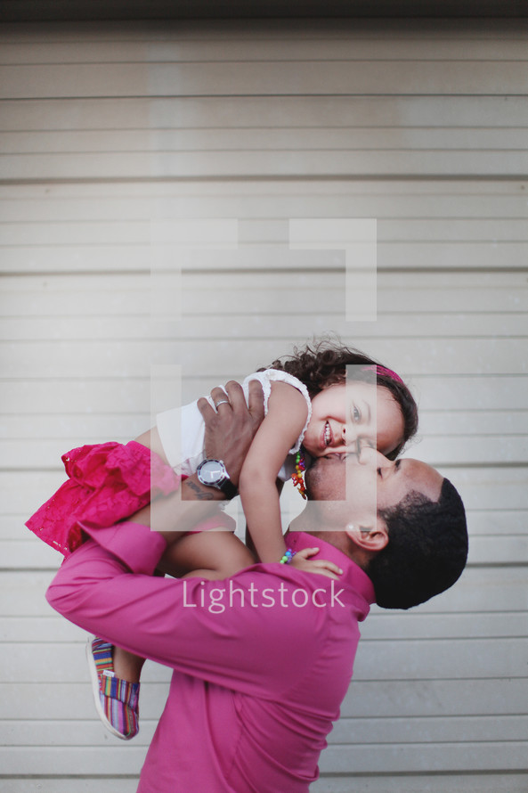 Father kissing daughter