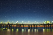 Star filled sky over a pier