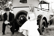 Bride and groom sitting on a vintage classic ford model T car 1920's