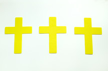 three yellow crosses on white background 