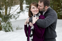 couple hugging in the snow 