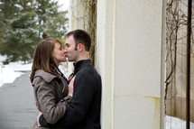 A man and woman kissing.