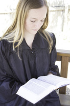 Graduate reading the Bible.