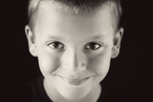 A headshot of a little boy smiling