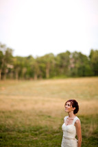 Bride in open grass field