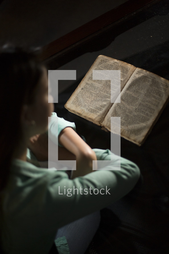 Woman reading old word Bible