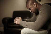 A man bowing his head in prayer