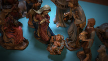 CGI Colorful Christmas Nativity set on coffee table focusing on Baby Jesus, Mary, and Joseph.