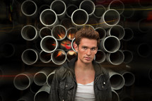 man standing in front of pipes