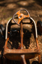 steering wheel on an antique steel metal toy car, childhood vintage, classic
