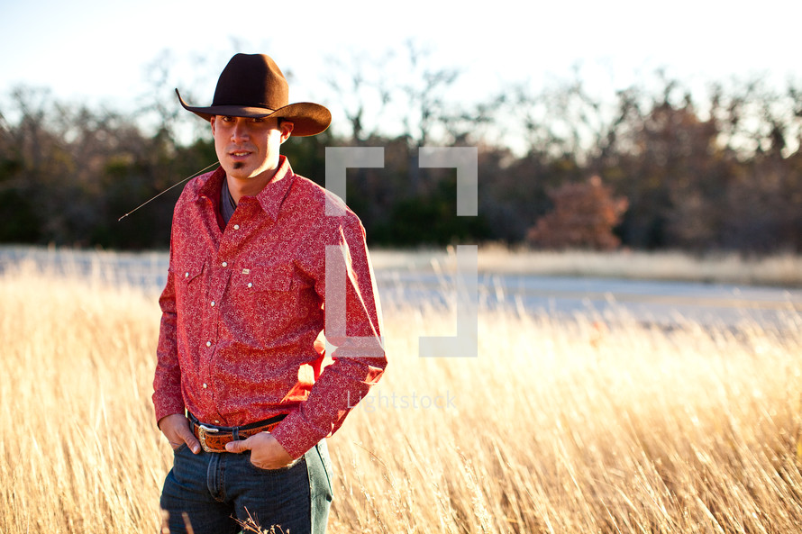 man in cowboy hat in a field