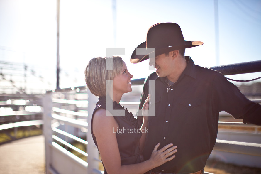 Couple in cowboy hat looking into each other's eyes