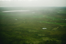 aerial view above the green landscape of Alaska 