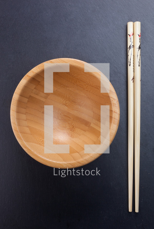 Chinese chopsticks with empty wooden bowl 