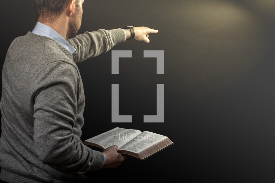 a preacher holding a Bible during his sermon 