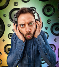 man with headphones and background with speakers