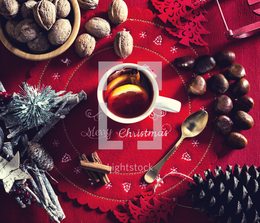Cup of hot tea with lemon and cinnamon on the Christmas table. View from above.