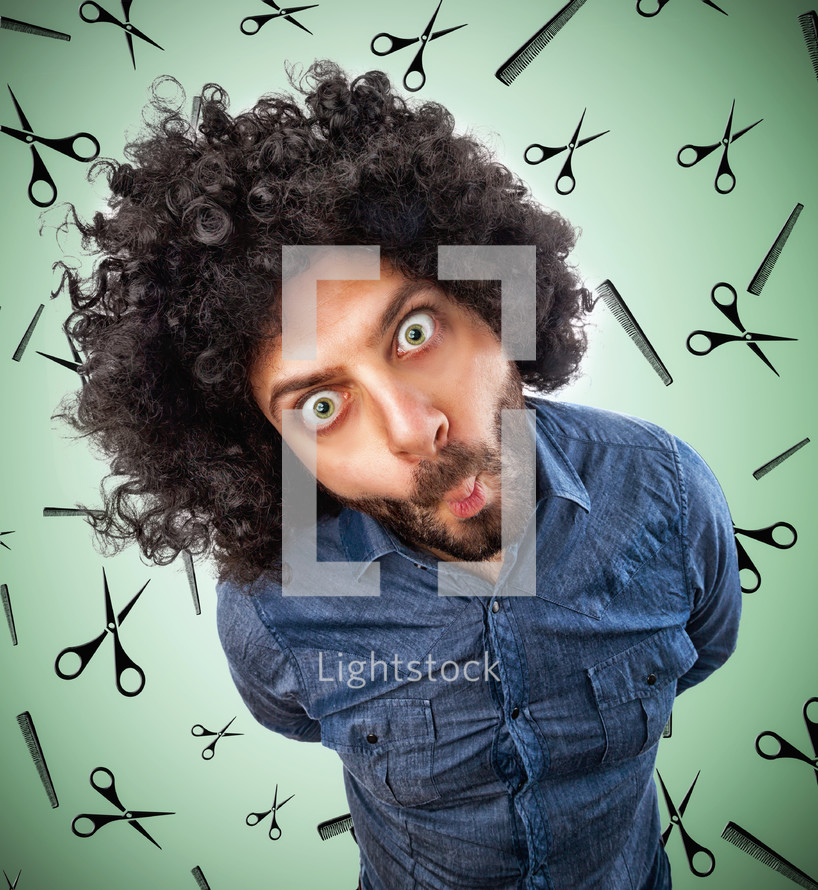 man with disheveled hair on background with scissors and combs