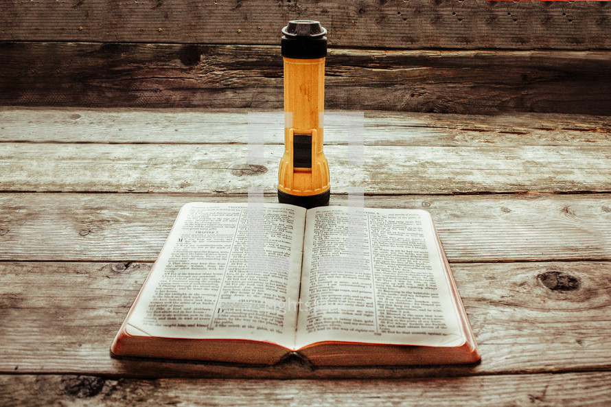 flashlight and open Bible 