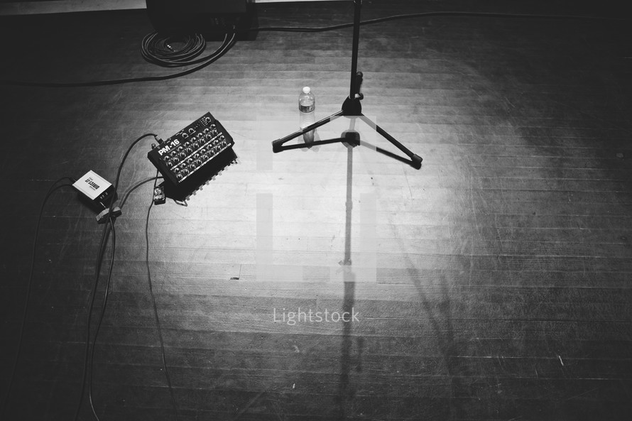 empty stage with guitar pedals and microphone stand