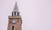 Church building and steeple against the white sky 