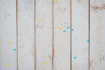 paint splatter on a white wood background 