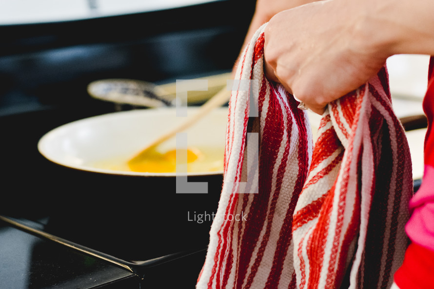 a woman cooking eggs in a kitchen 